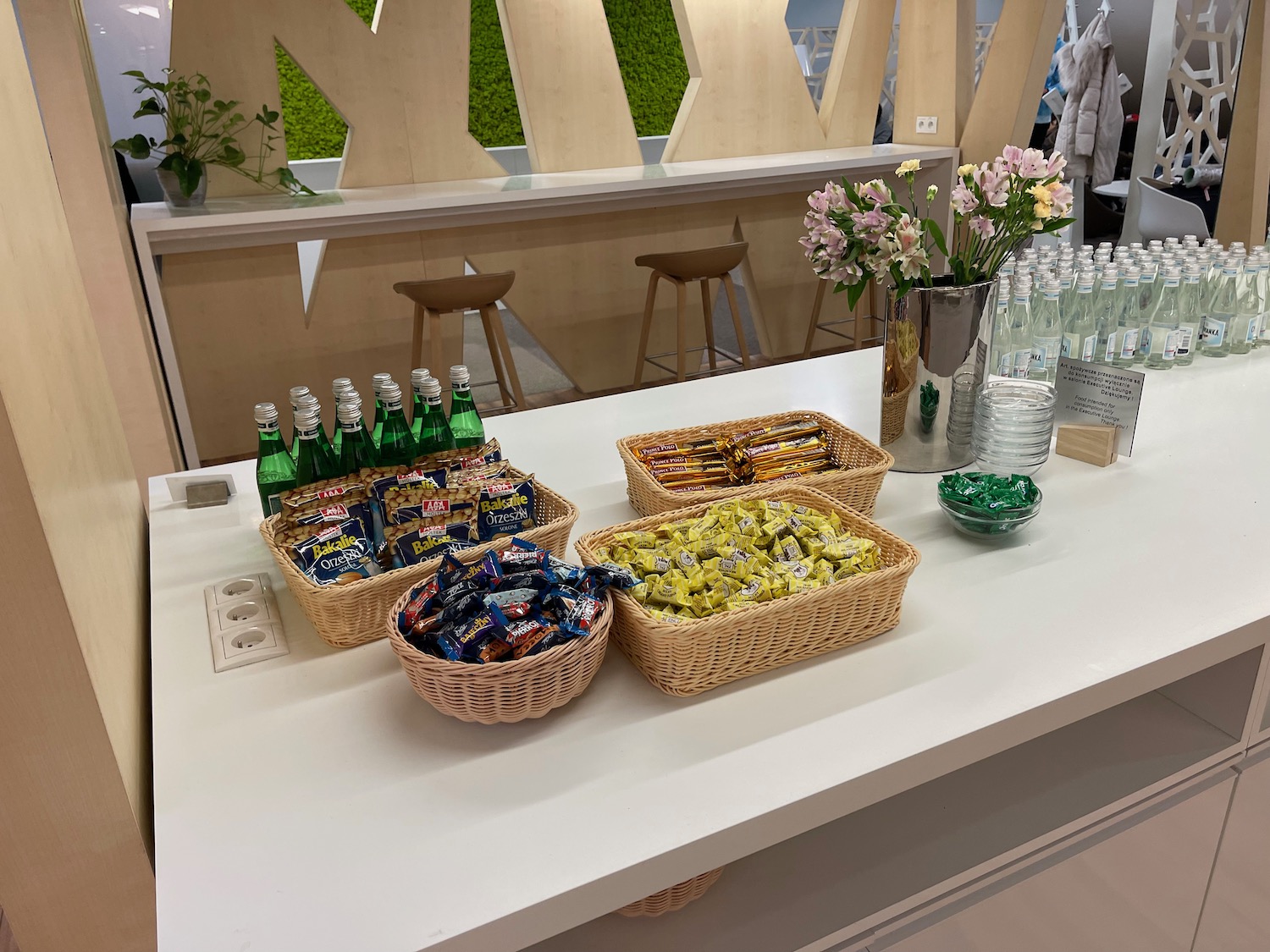 a table with baskets of candy and bottles