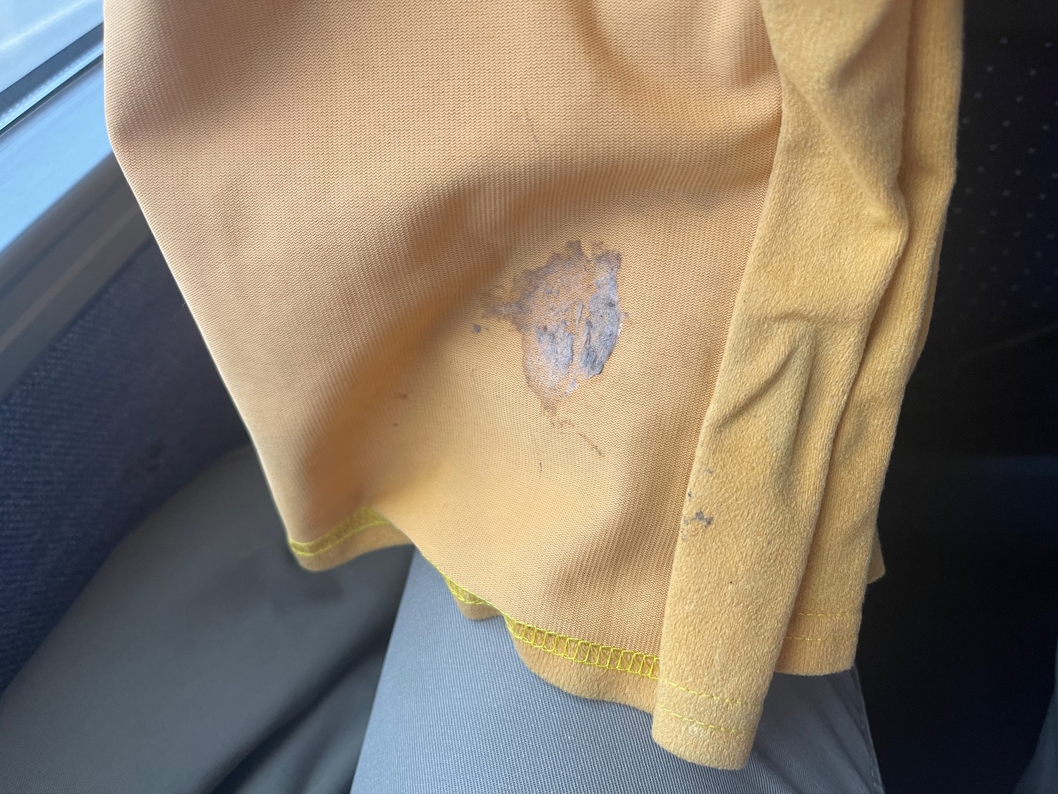 a stain on a yellow shirt