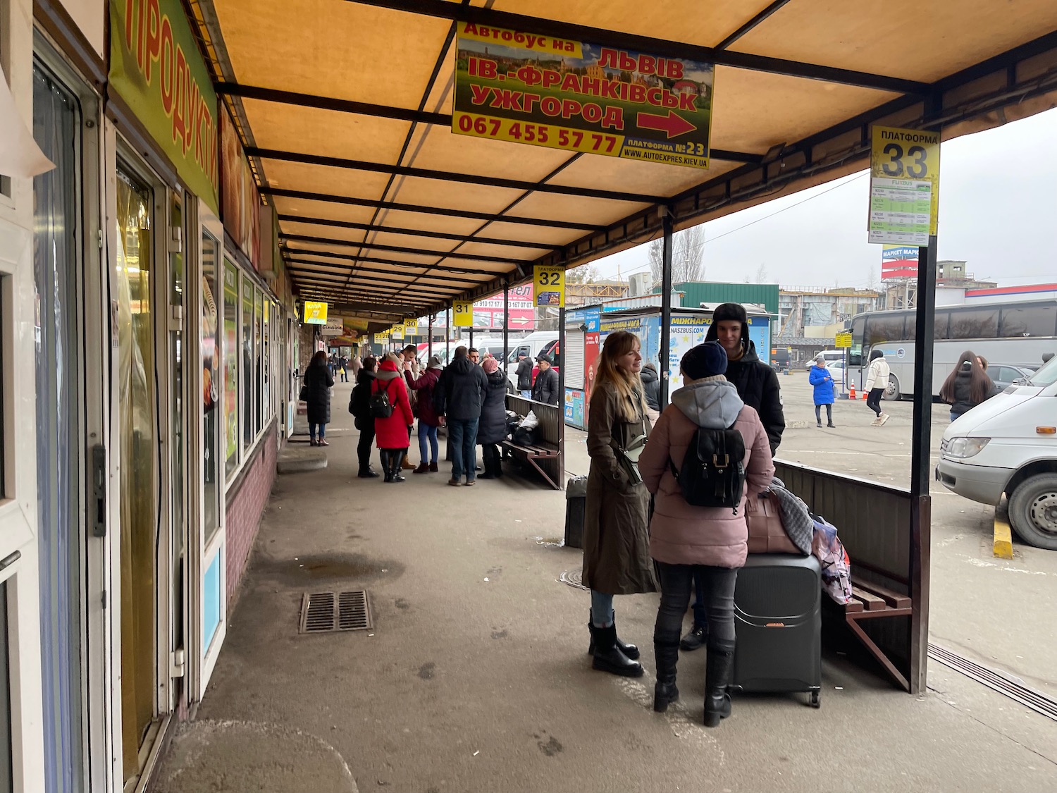 people standing in a covered area with people standing in front of them