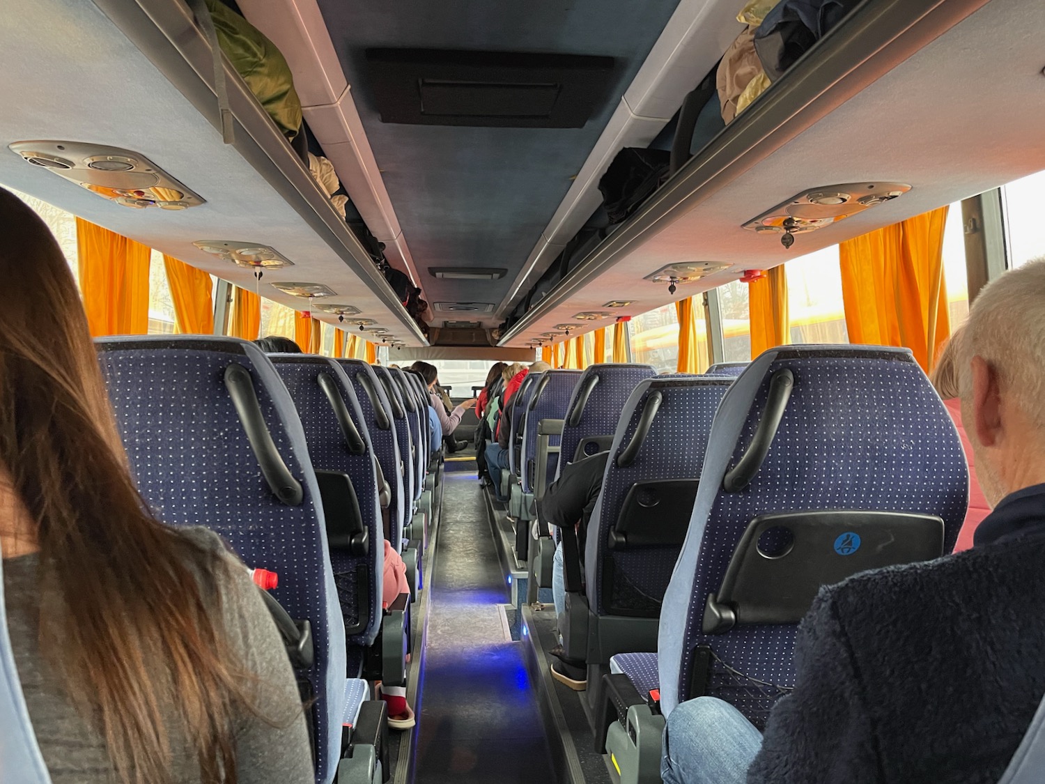 a group of people sitting on a bus