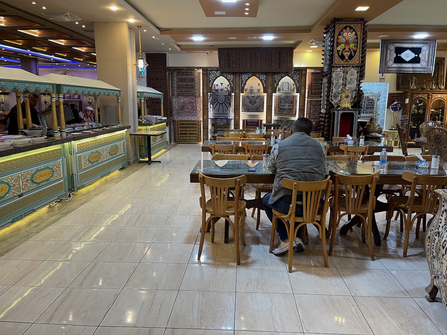 a man sitting at a table in a restaurant