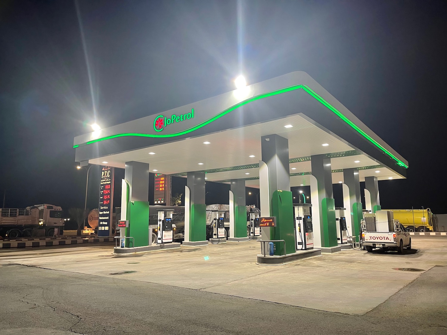 a gas station with green and white gas pumps