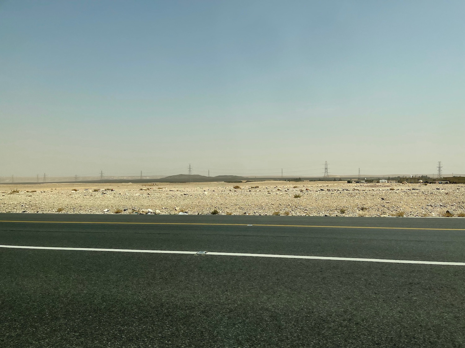 a road with a desert landscape