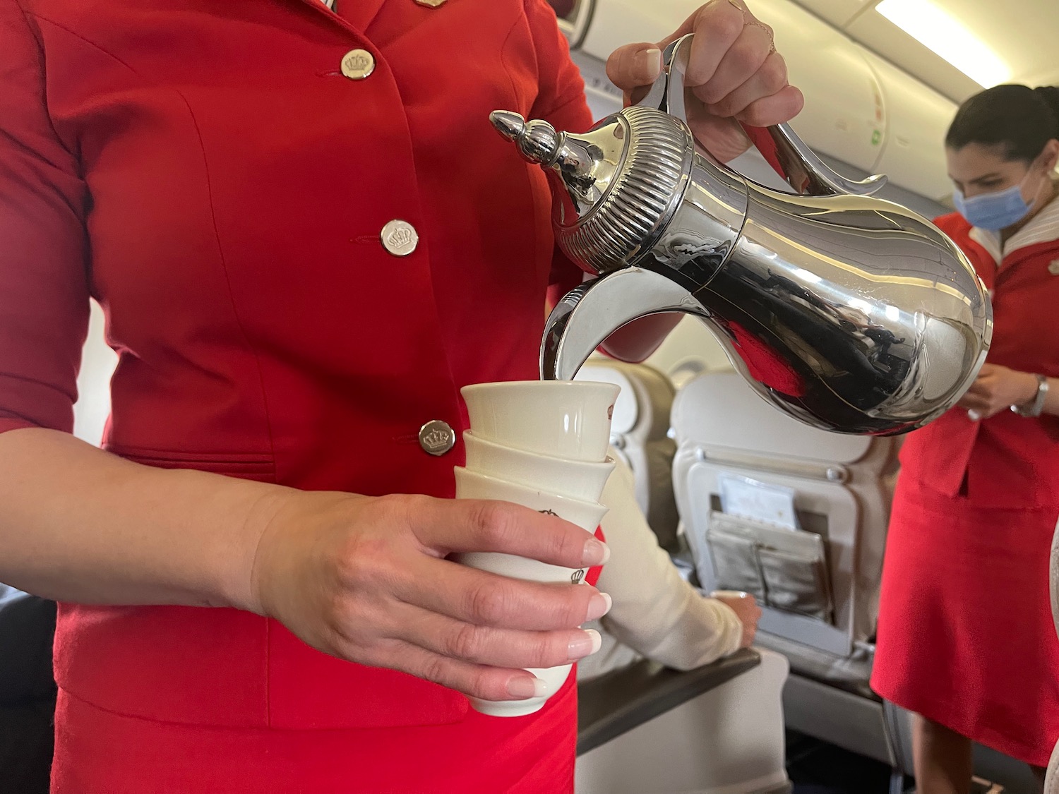 a person pouring coffee into a cup