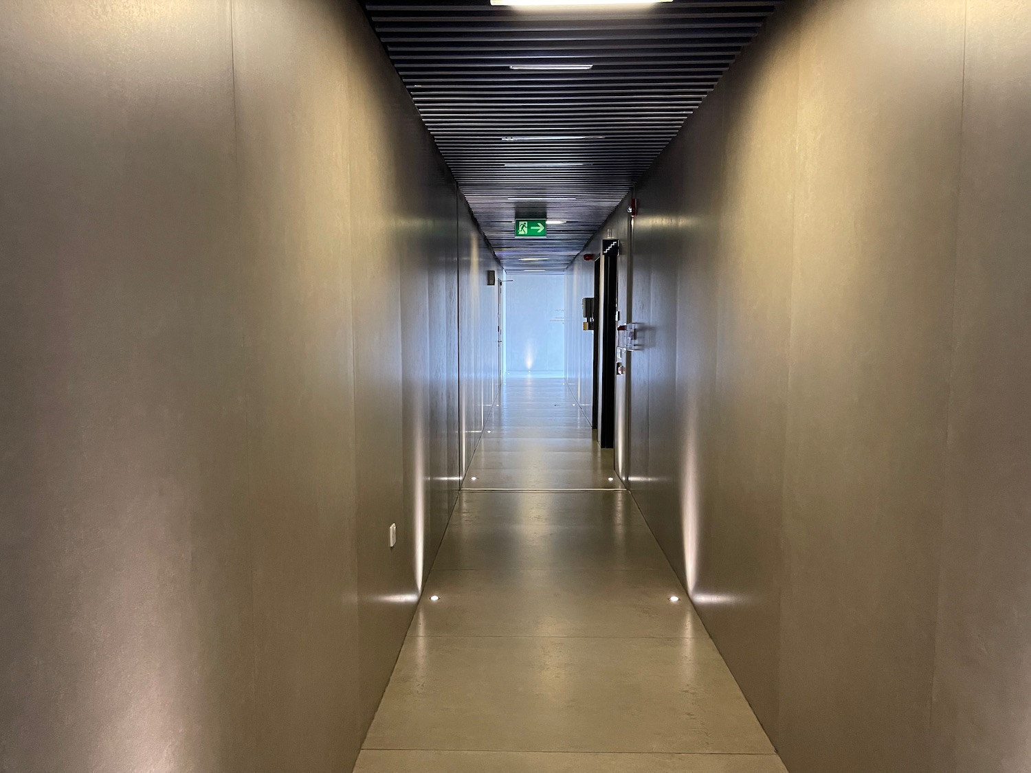 a hallway with a light on the wall