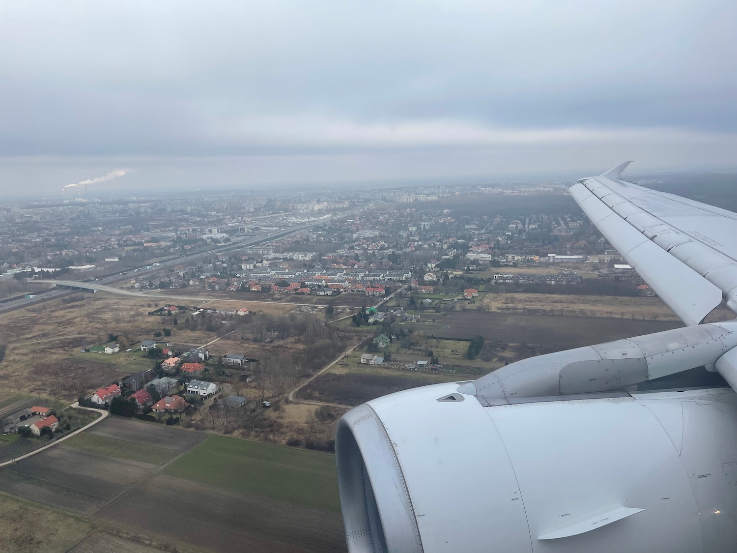 an airplane wing and a city