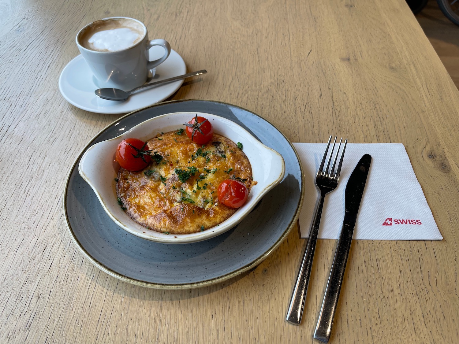 a plate of food and a cup of coffee