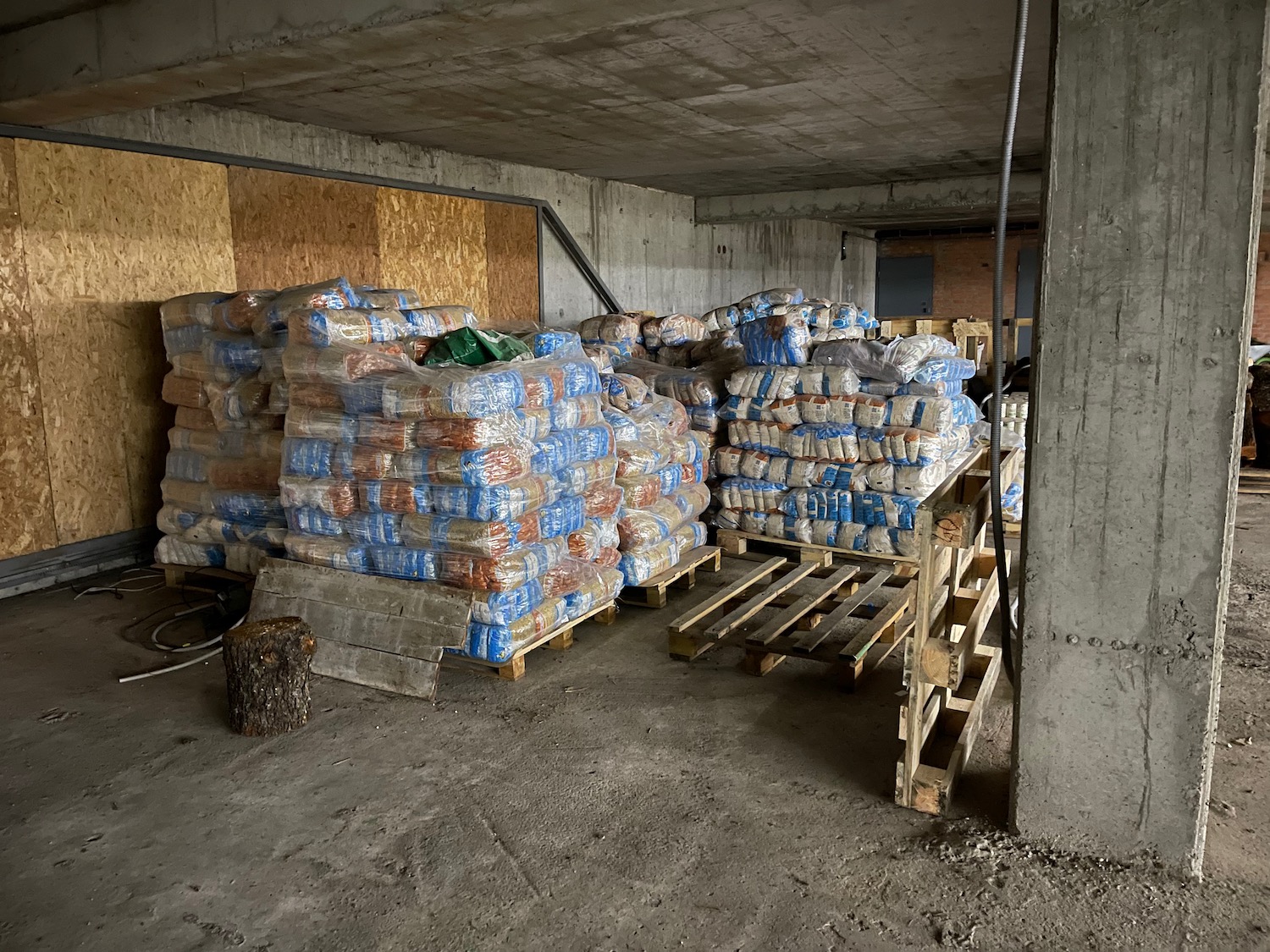 pallets of cement and bags of cement in a building