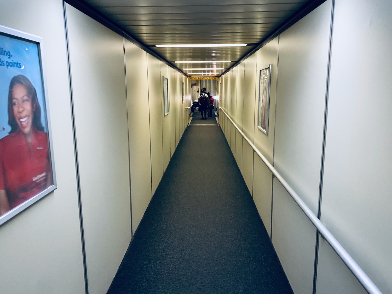 a long hallway with people walking on it