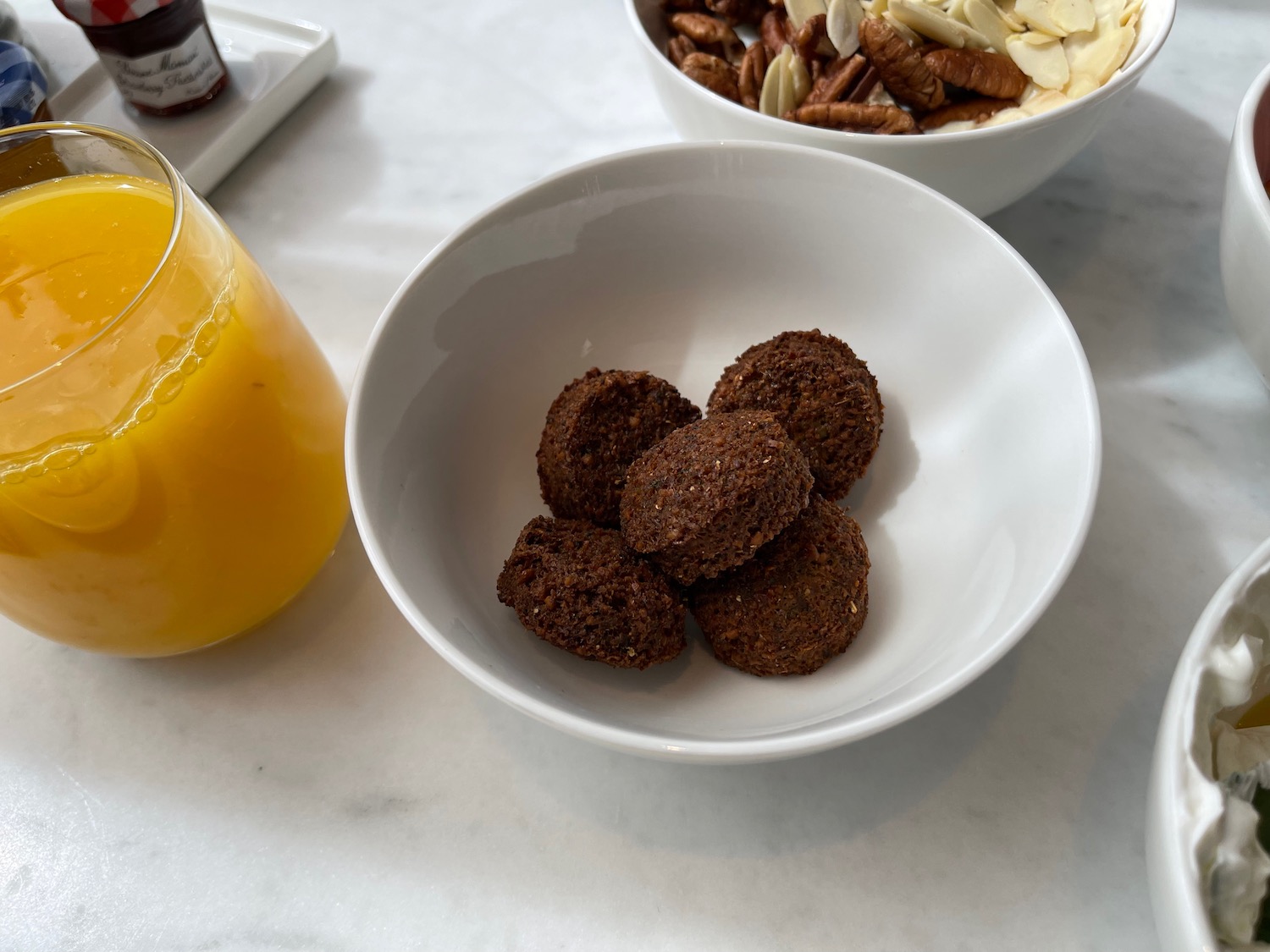 a bowl of food and a glass of orange juice