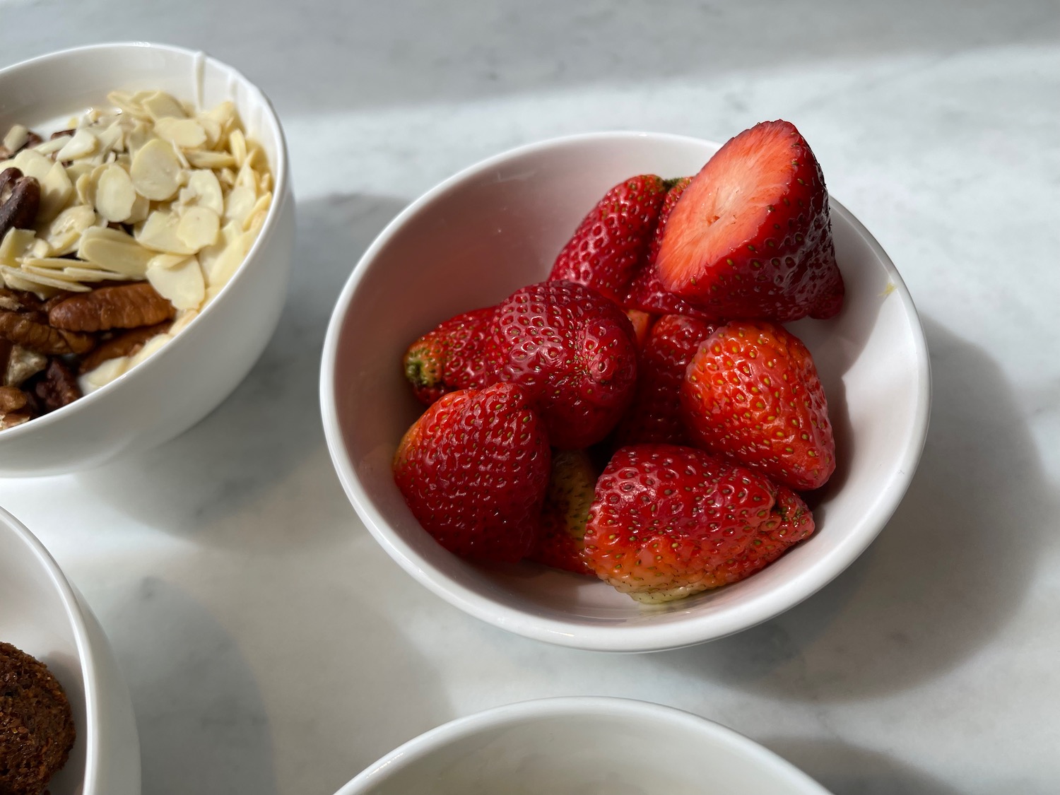 a bowl of strawberries and a bowl of almonds