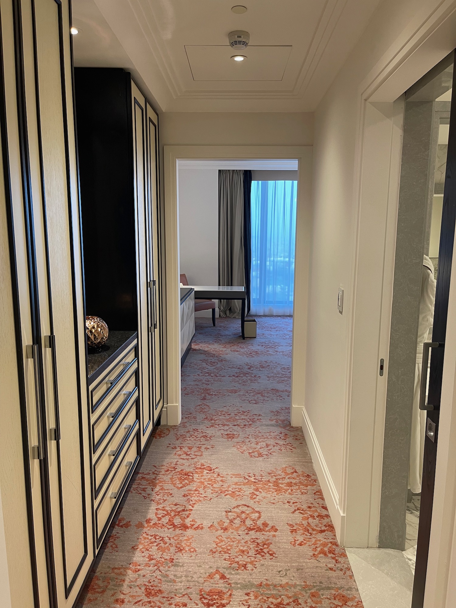 a hallway with a red and white carpet