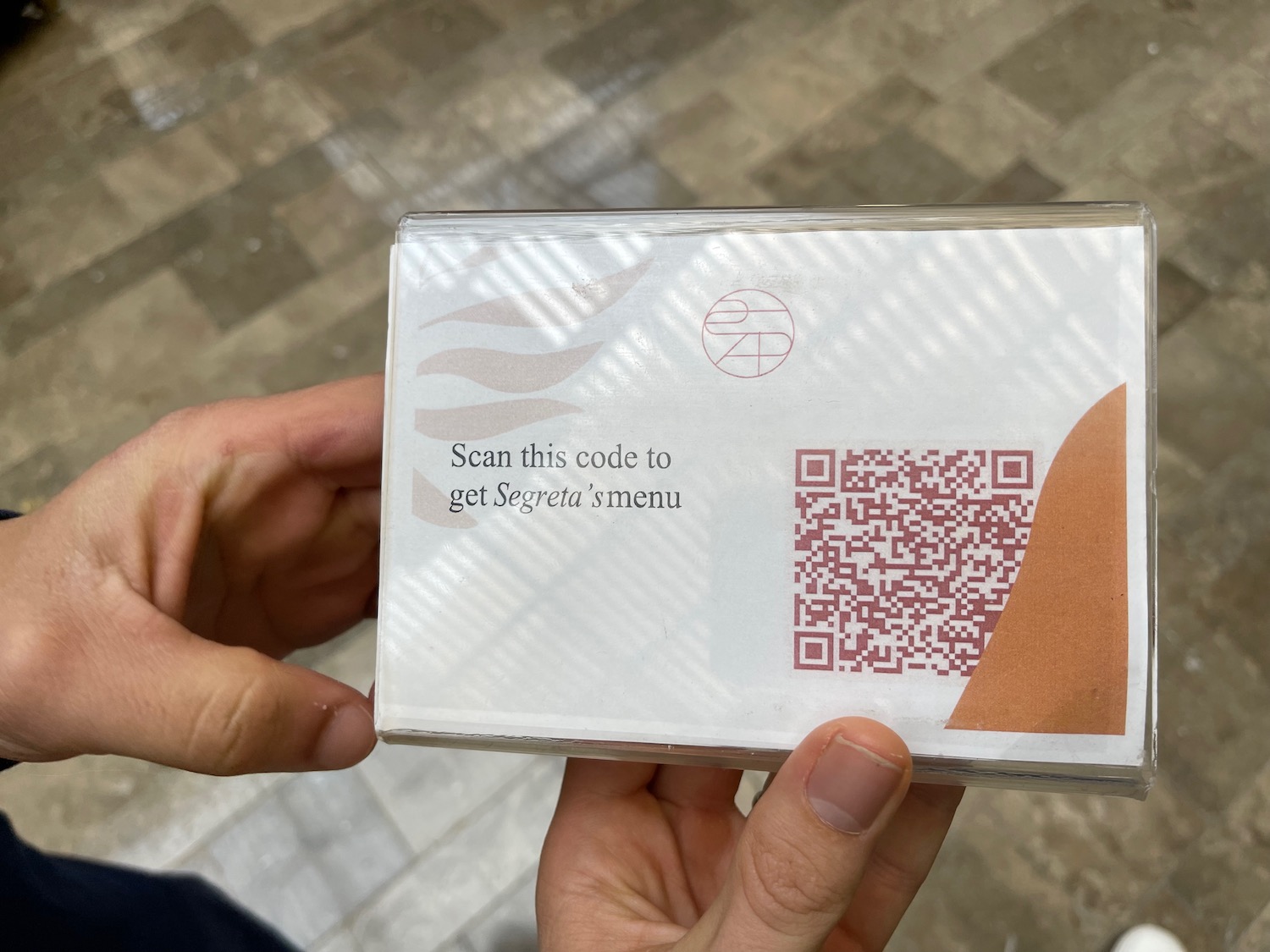 a person holding a box with a qr code