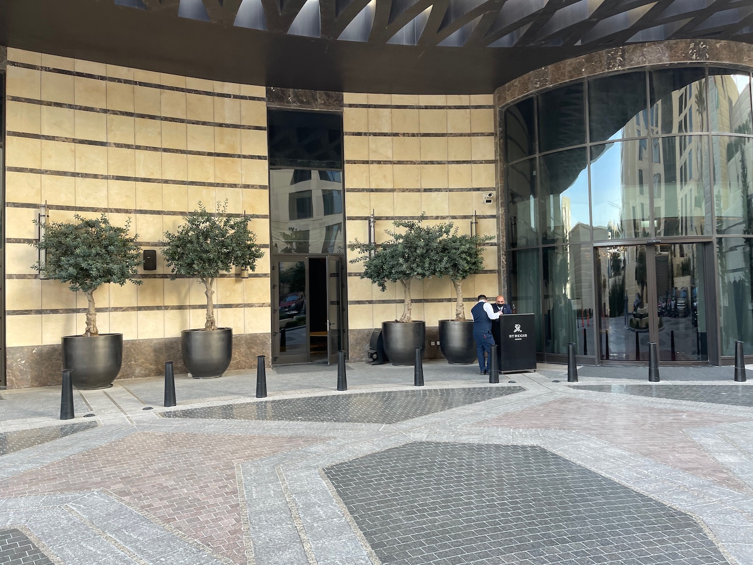 a building with glass doors and trees