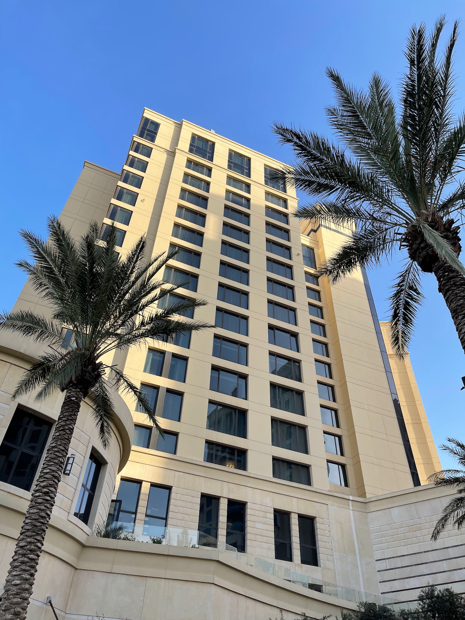 a tall building with palm trees