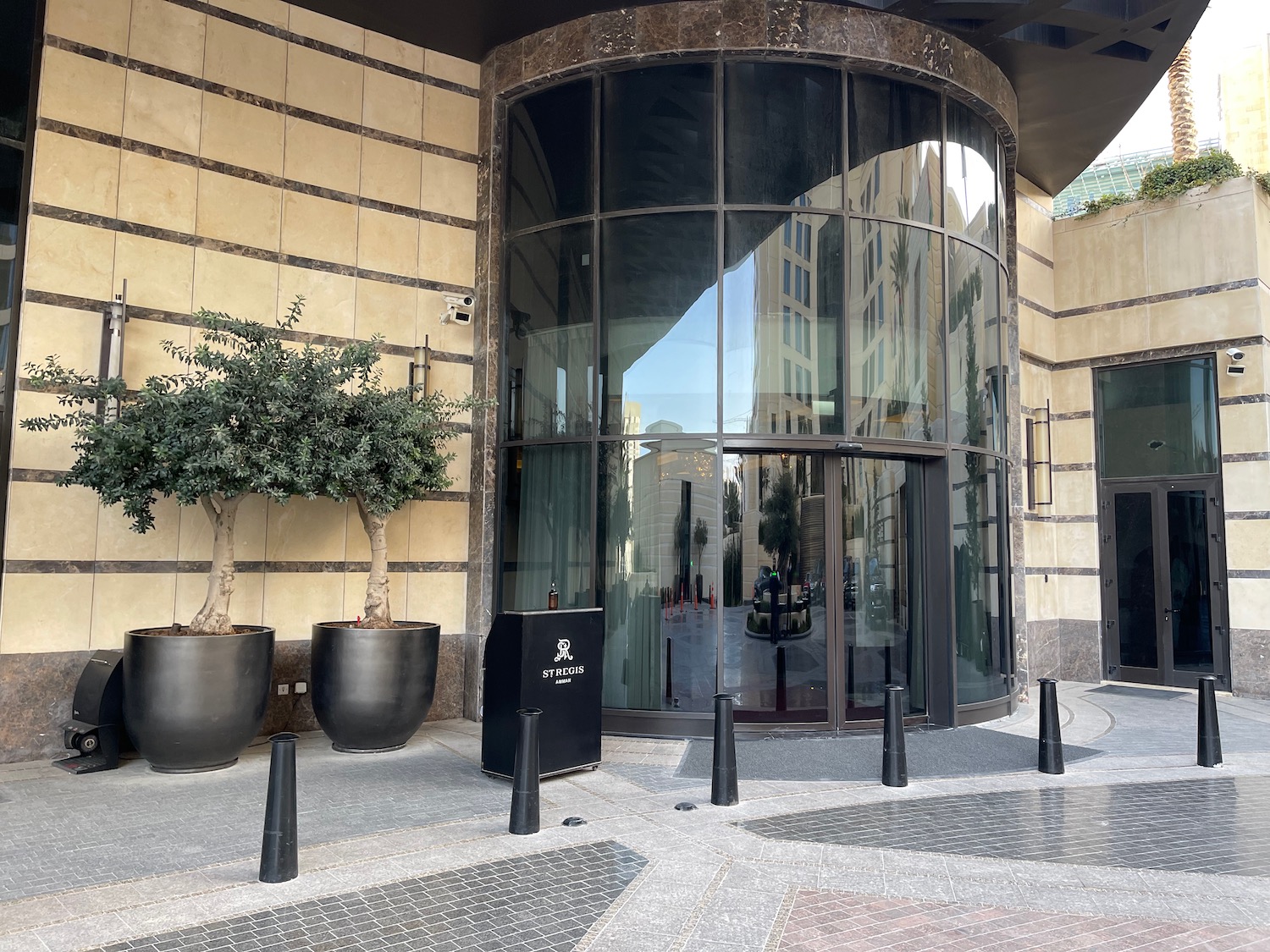 a building with glass doors and trees