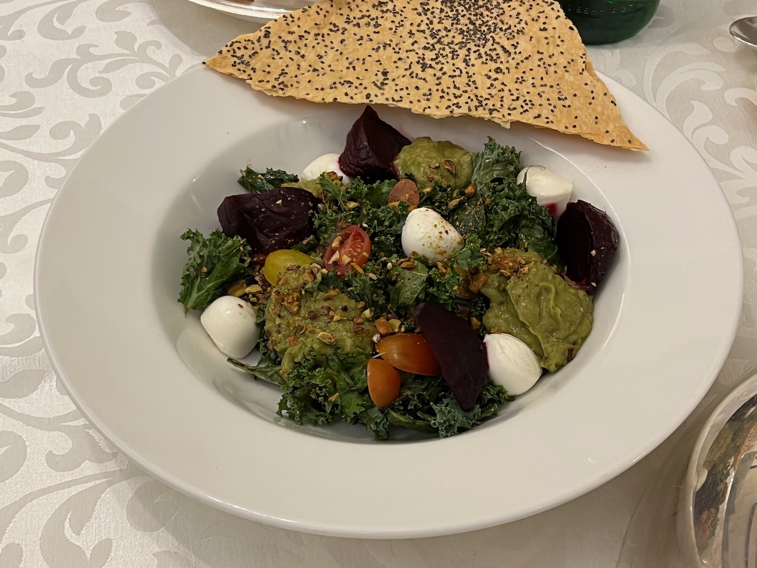 a plate of salad with a tortilla and a piece of bread