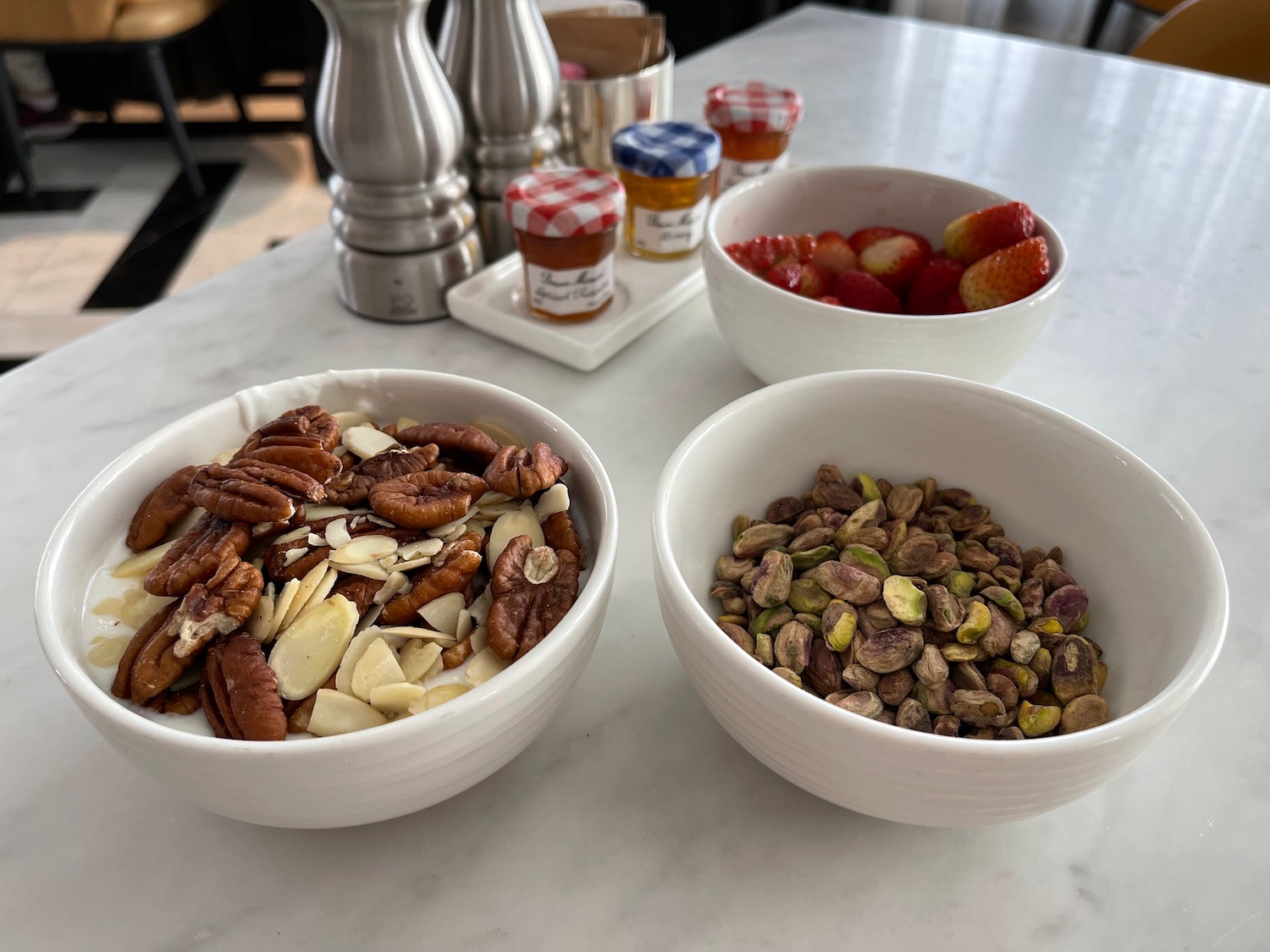 bowls of nuts and strawberries on a table