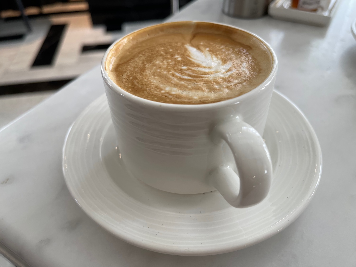 a cup of coffee on a white table