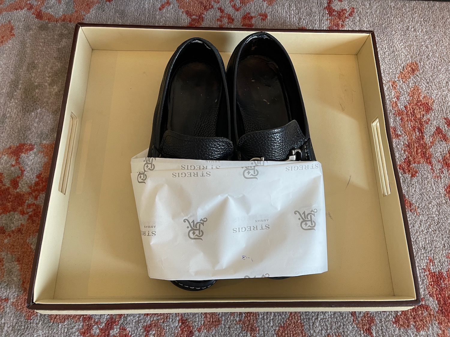 a pair of black shoes in a box