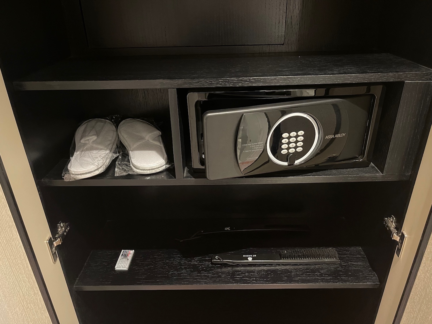 a black shelf with a combination lock and shoes