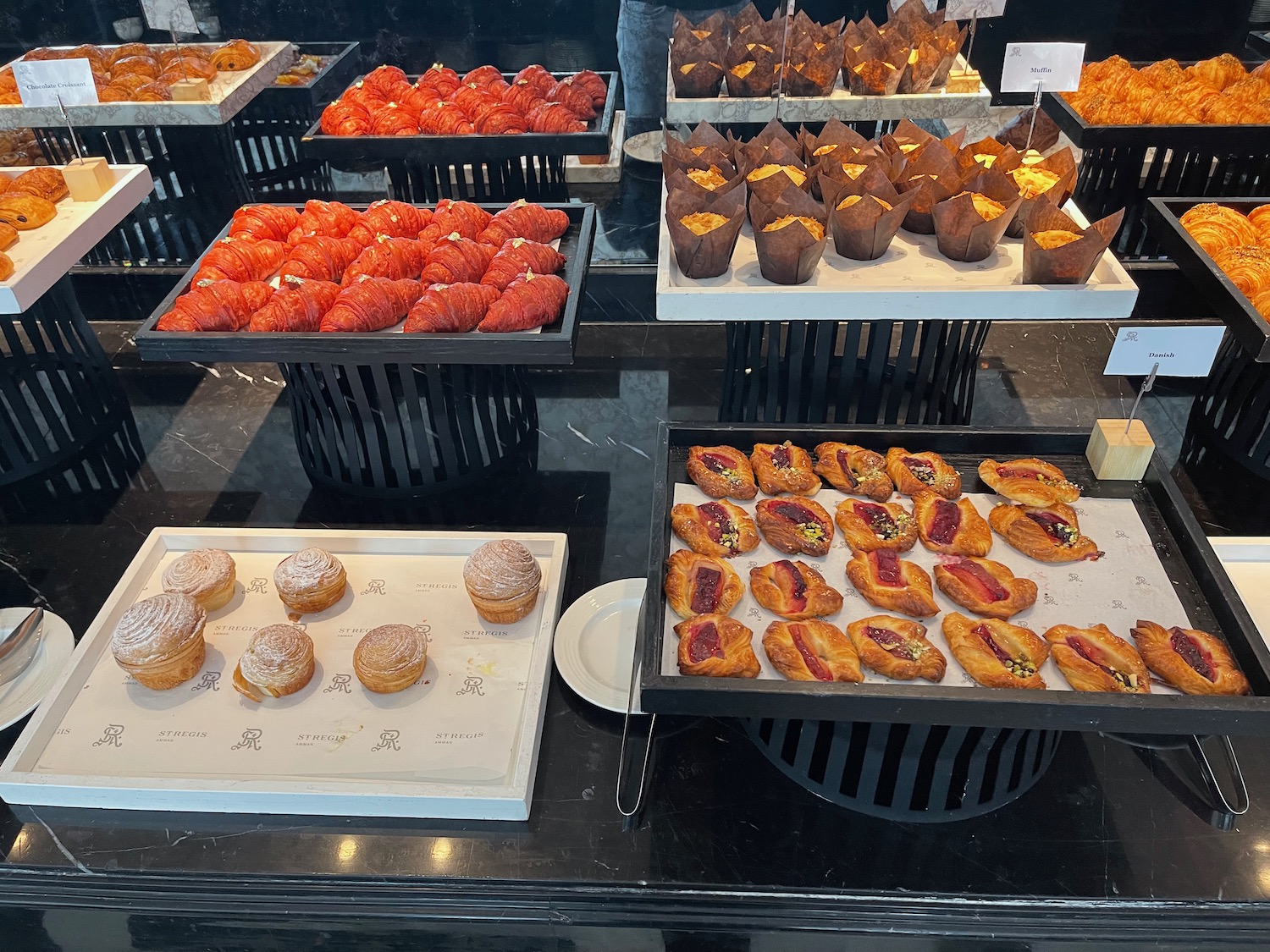 a group of trays of pastries and pastries on a table