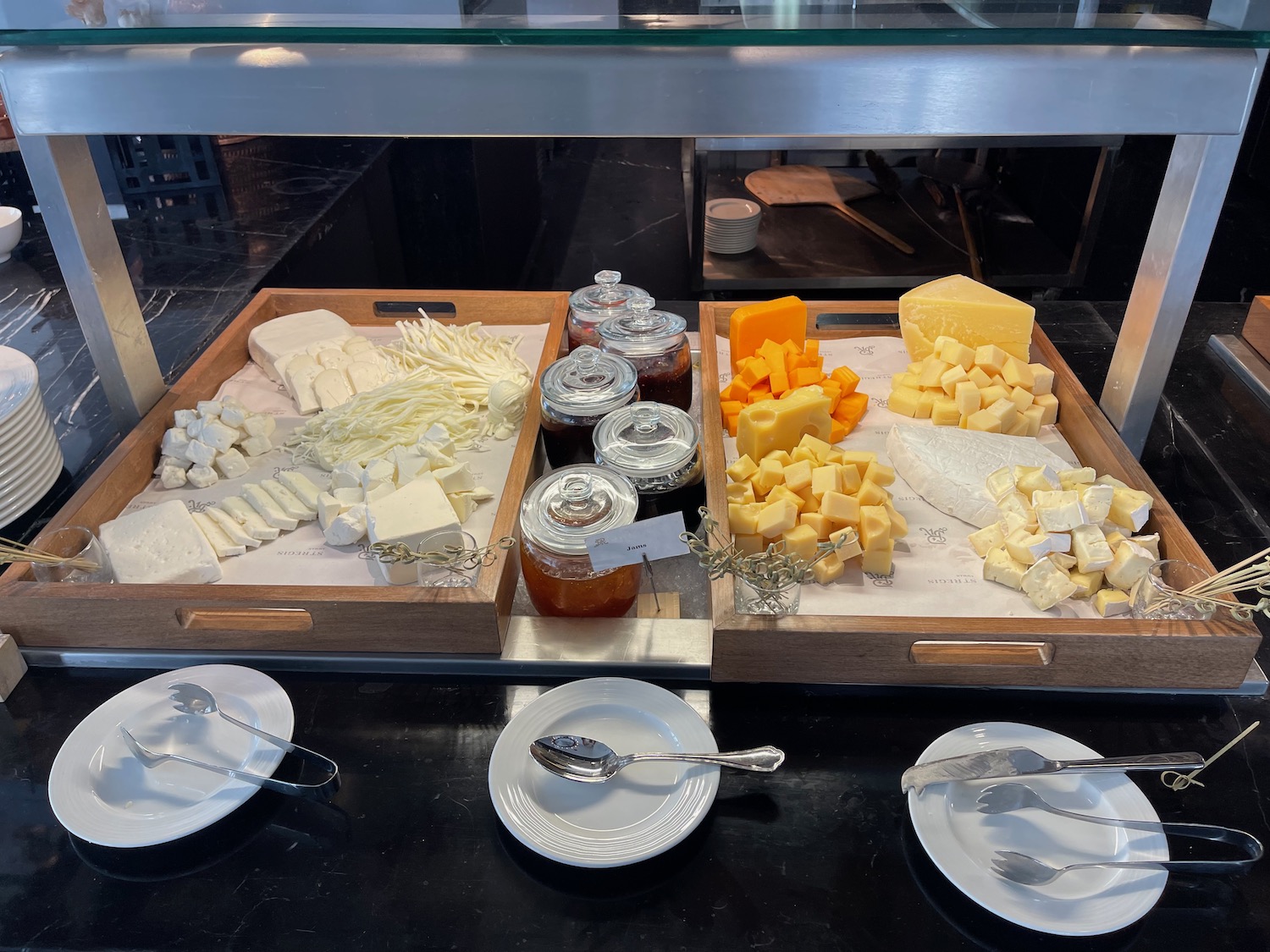 a trays of cheese and jams on a counter