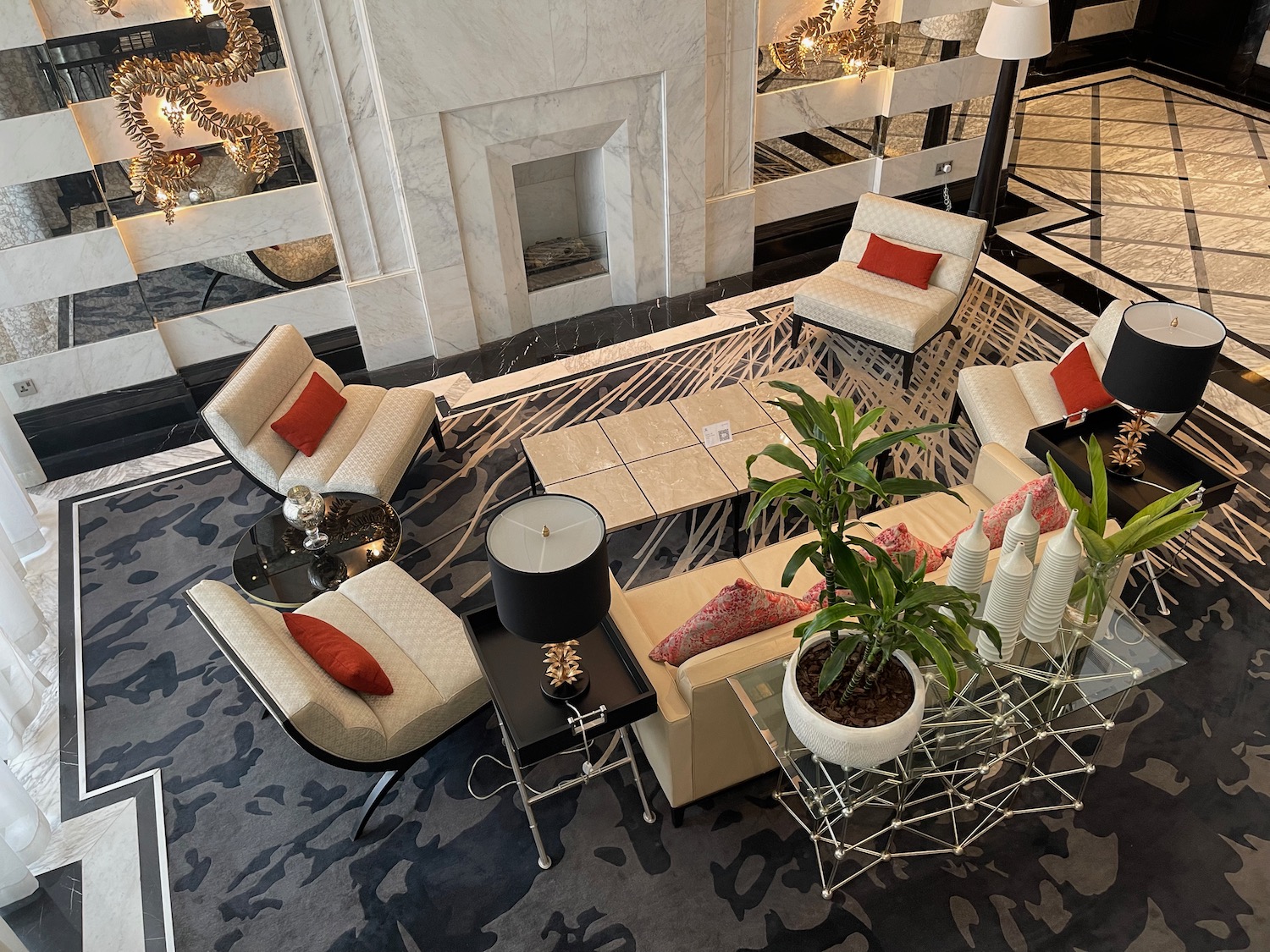 a room with white furniture and a black and white fireplace