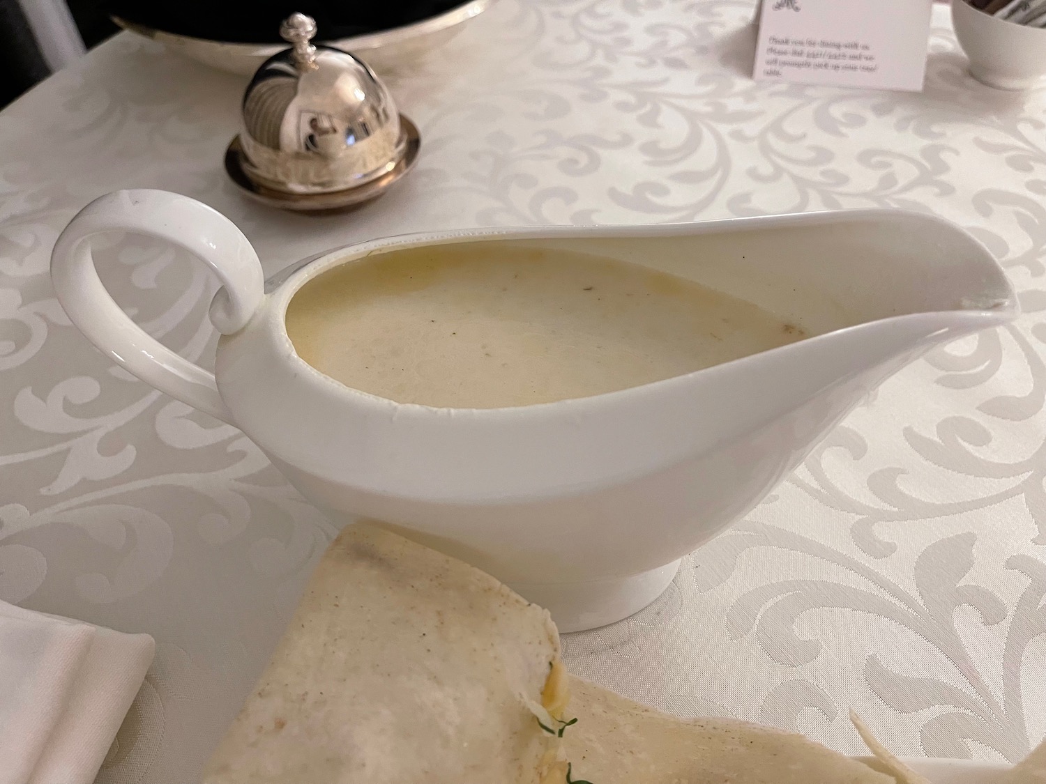 a white sauce boat on a table