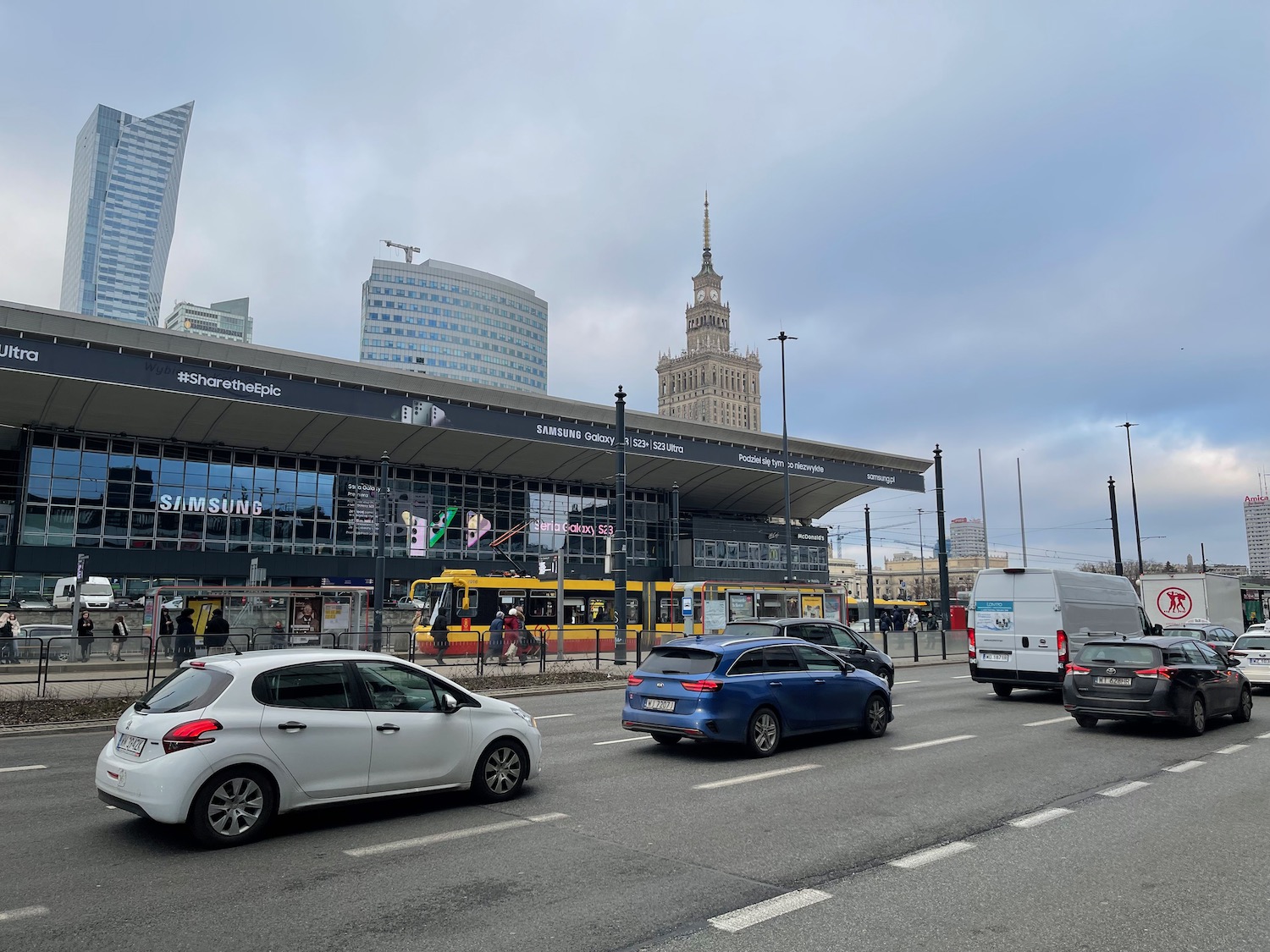 a street with cars and a building in the background