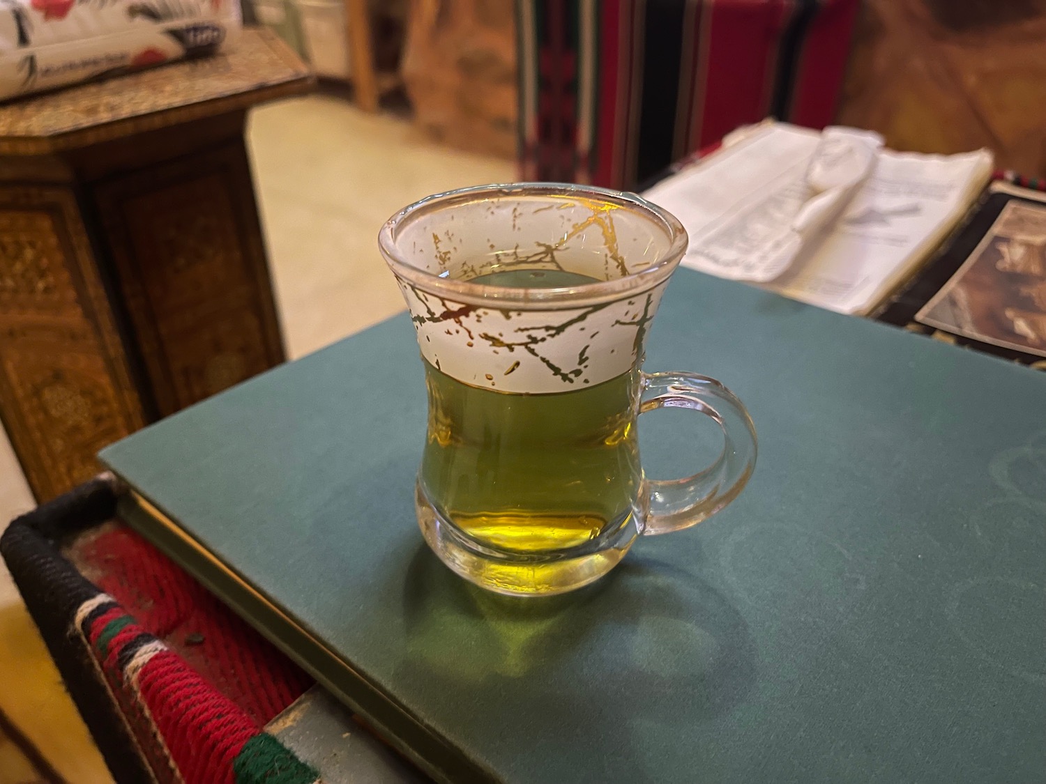 a glass of liquid on a book