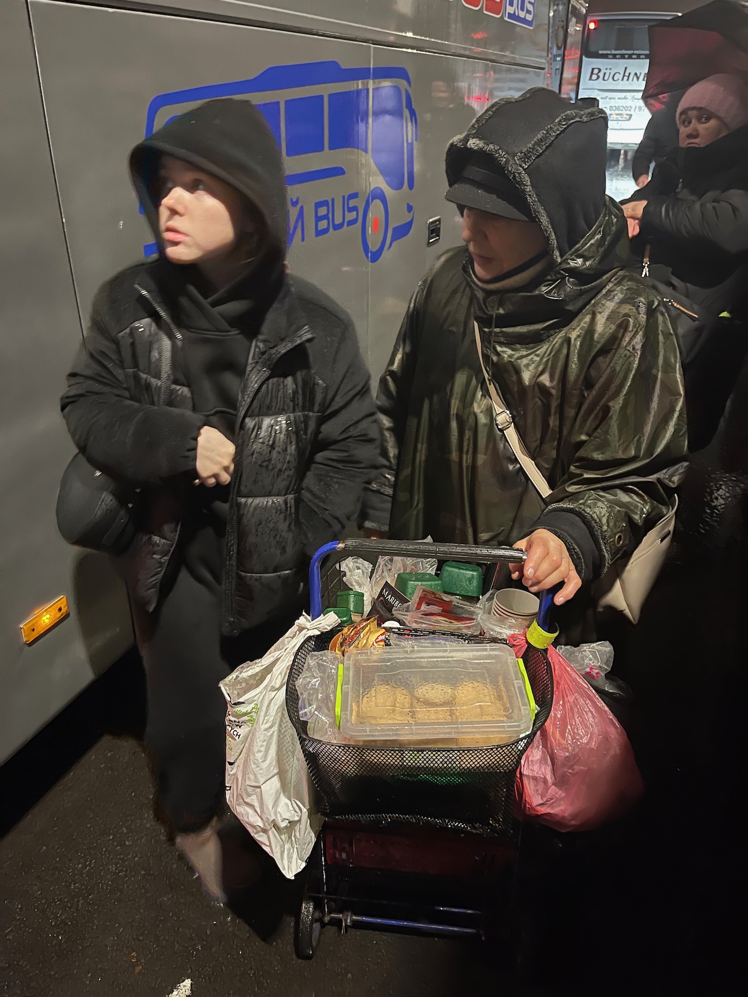 a group of people standing in a subway