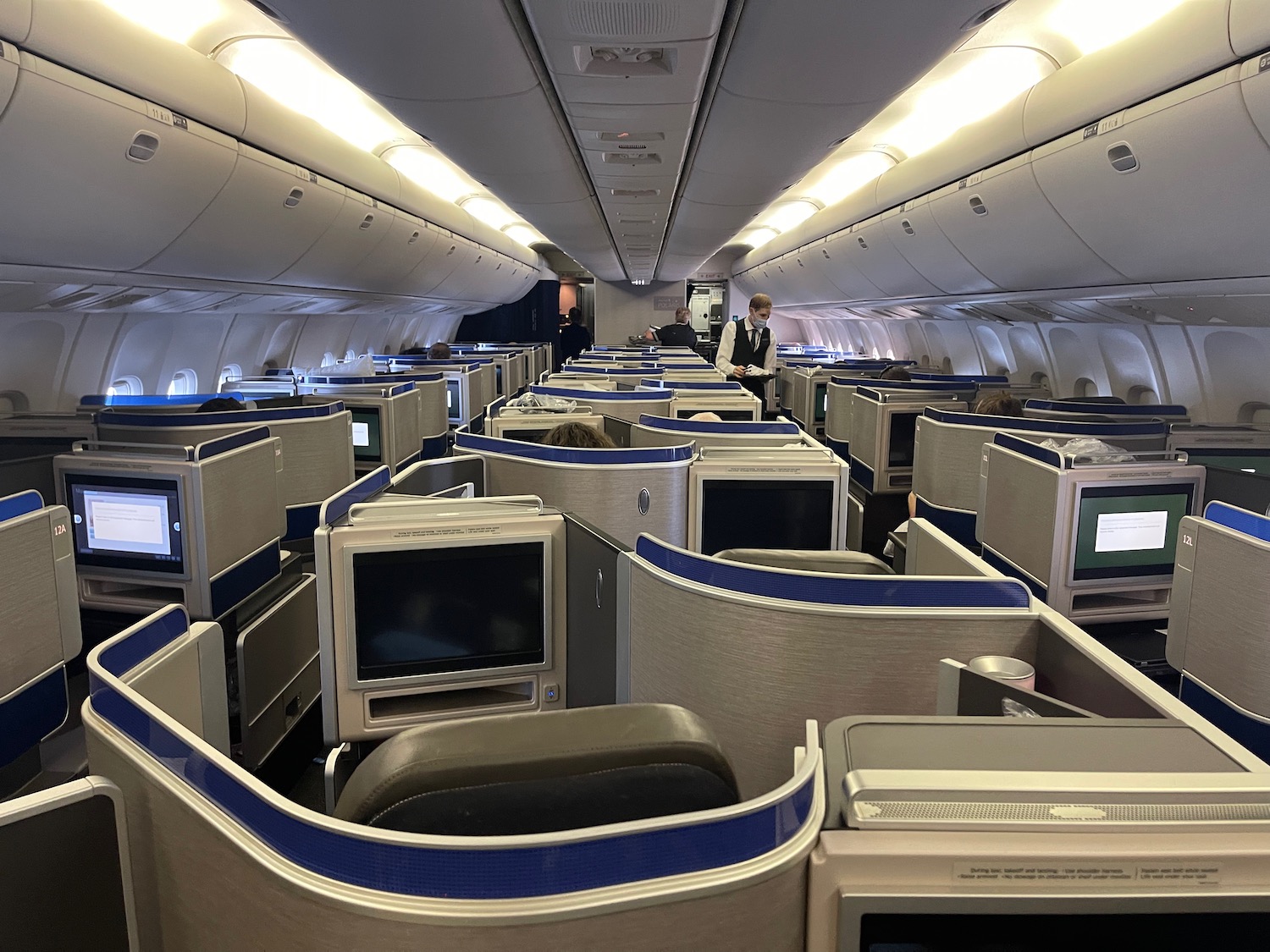 a plane with rows of monitors and people