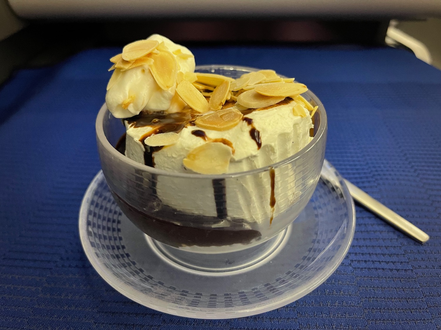 a bowl of ice cream with almond flakes