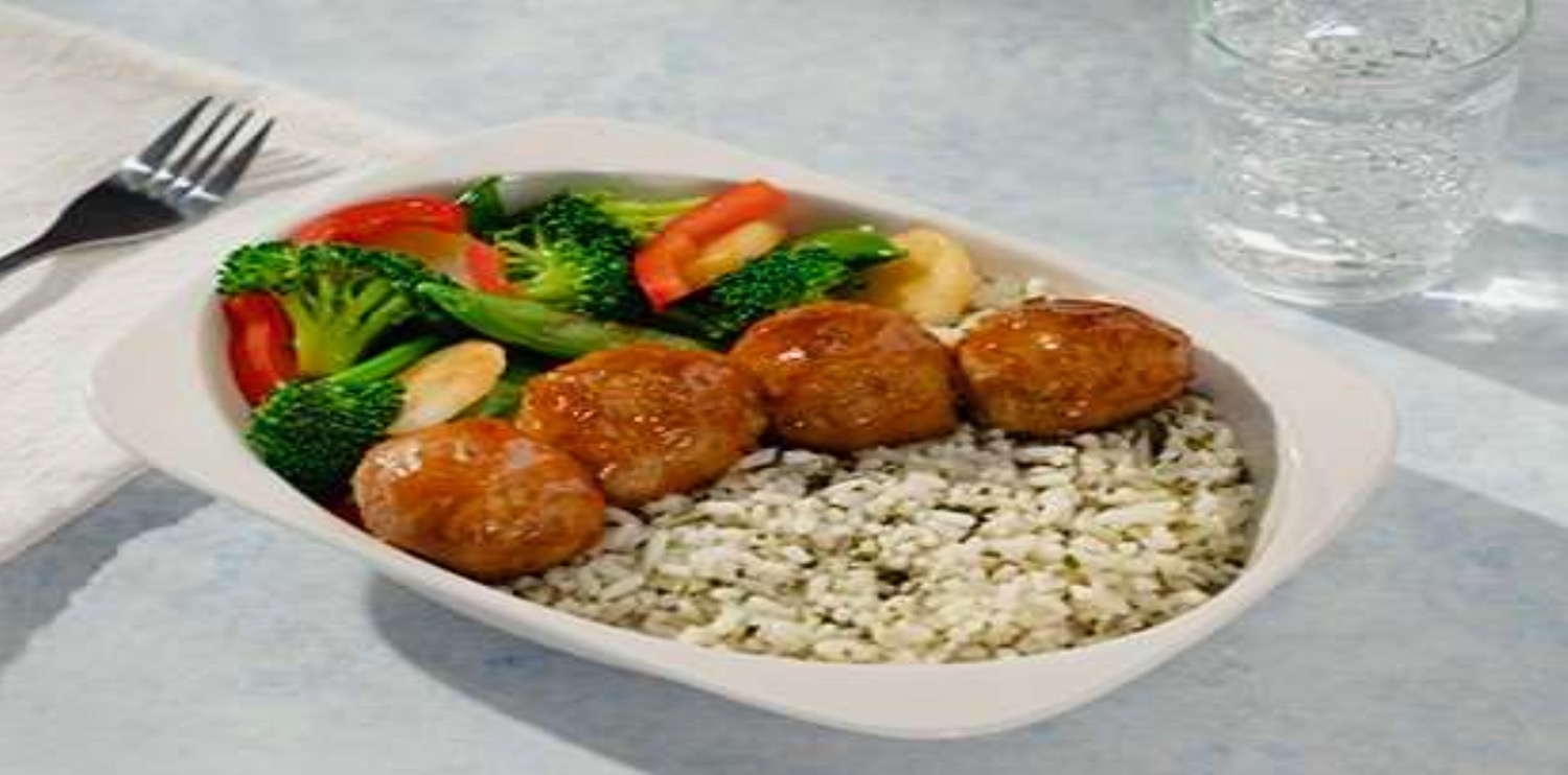 a plate of food with meatballs and rice