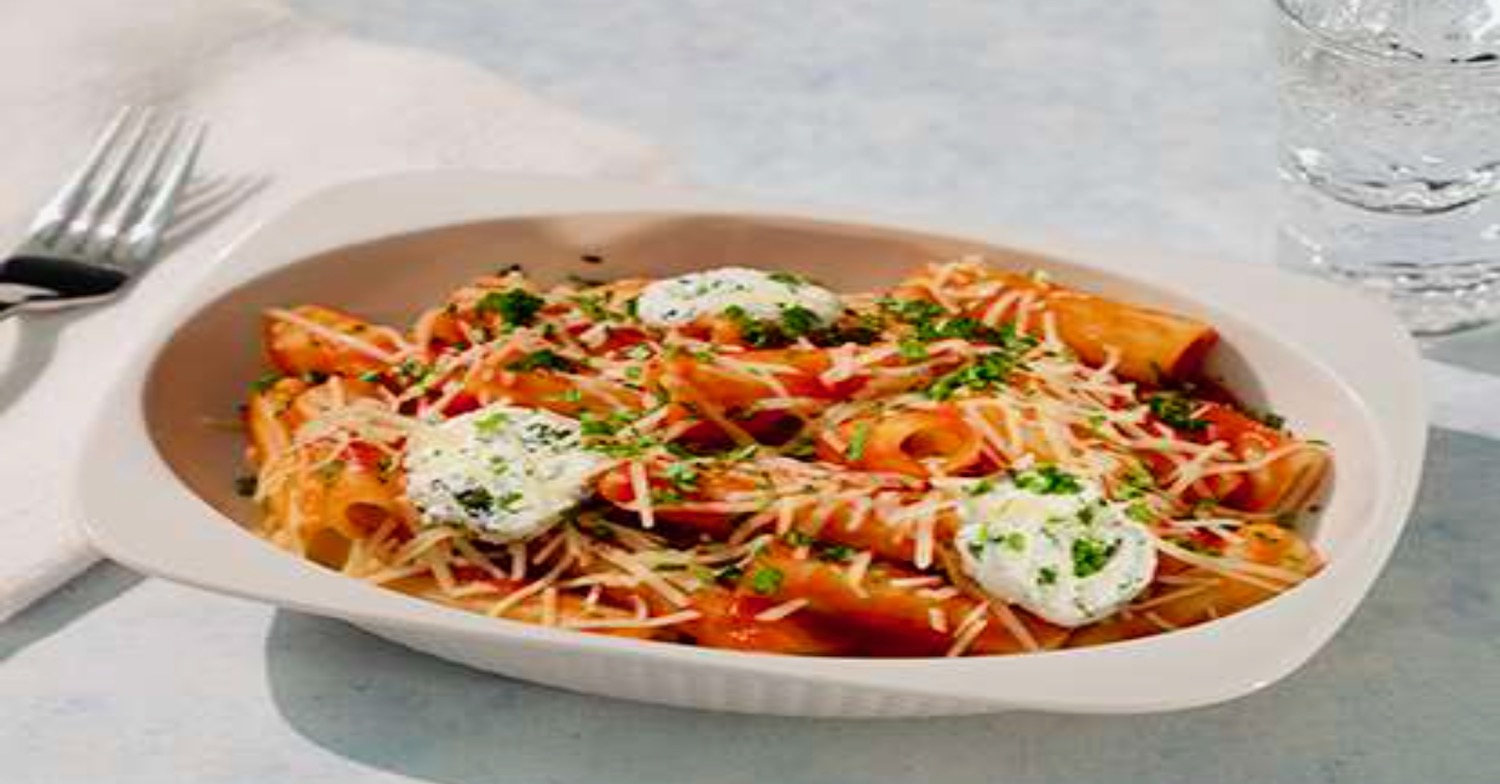 a plate of pasta with cheese and sauce