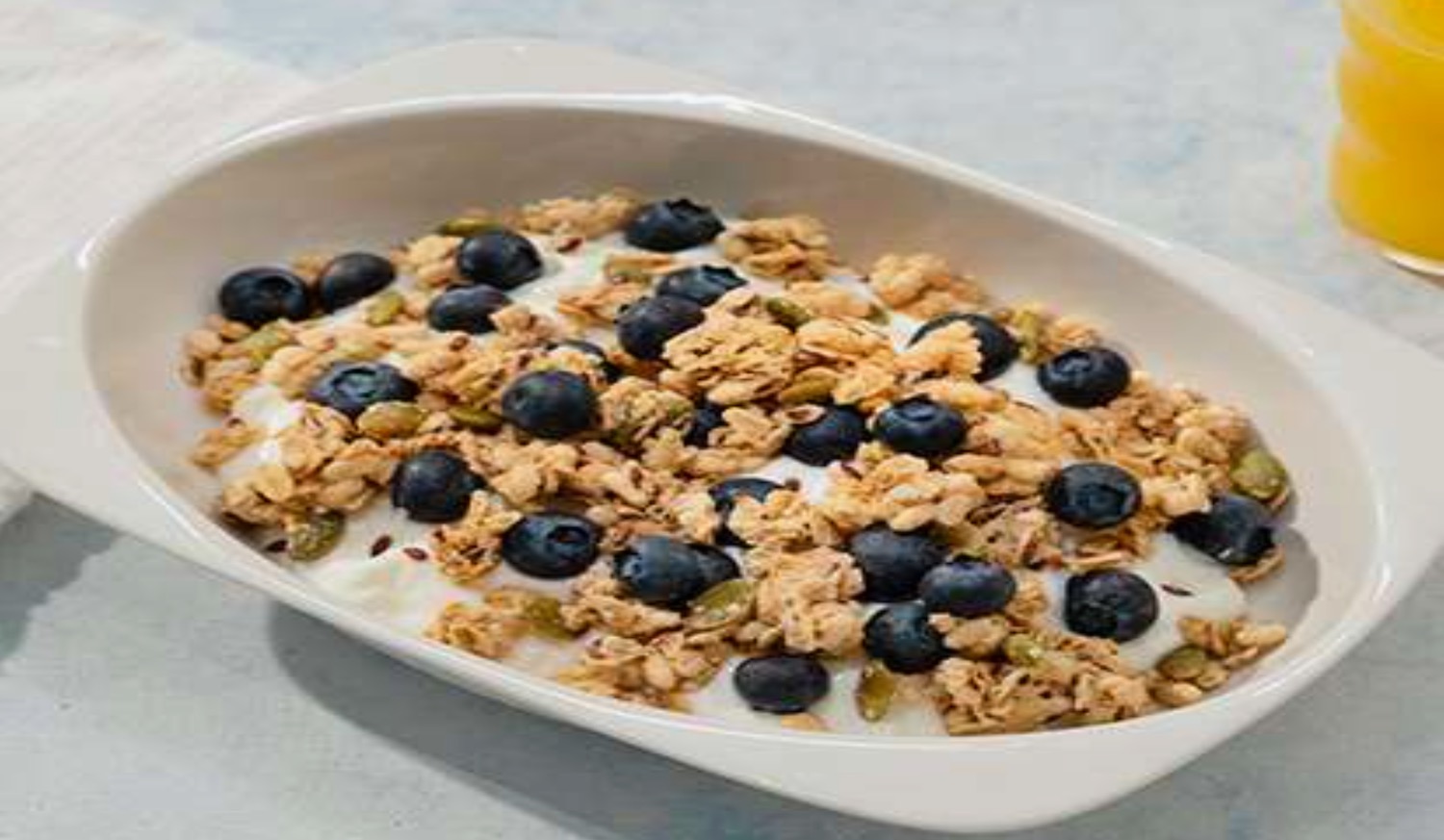 a bowl of cereal and blueberries