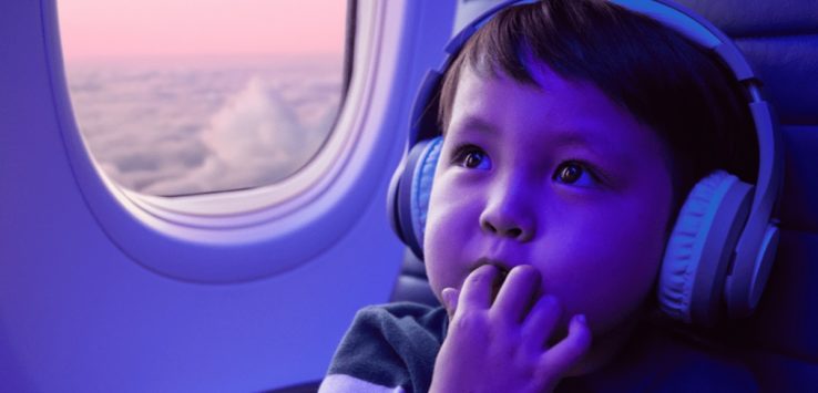 a child in a plane with headphones