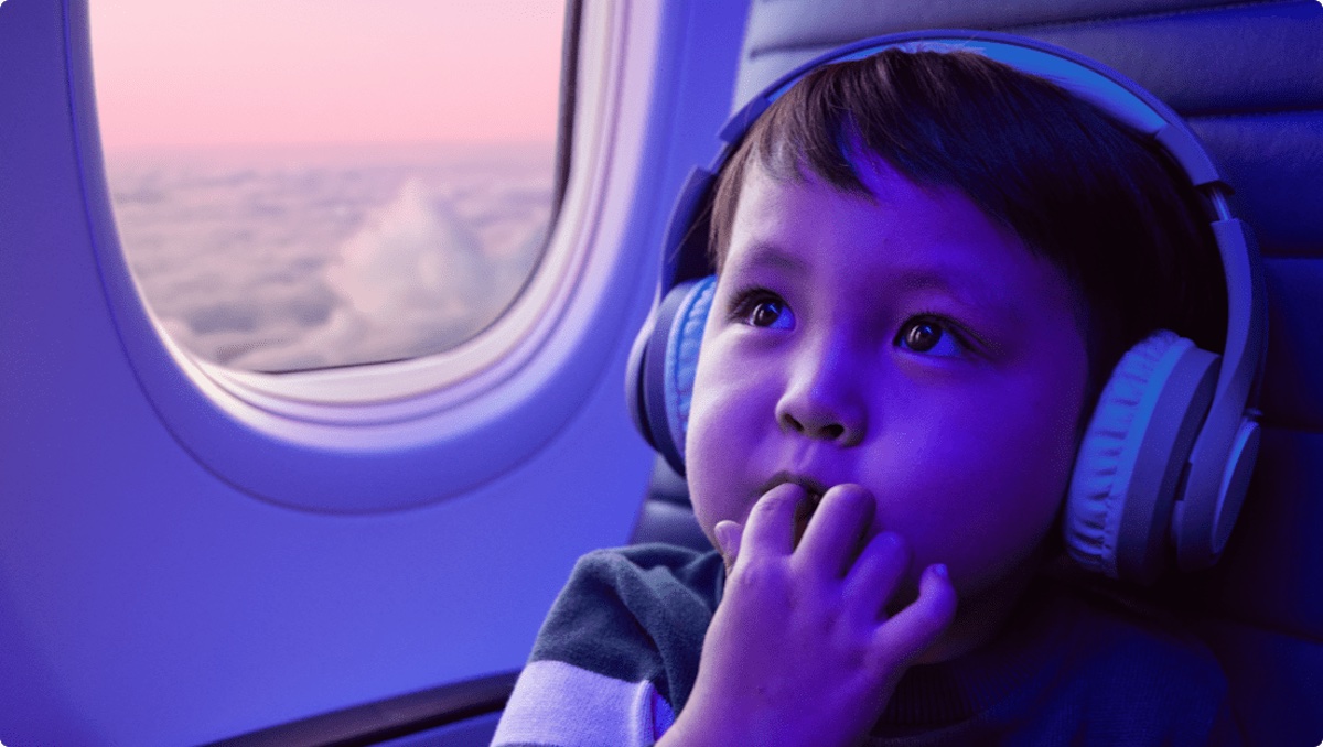 a child in a plane with headphones
