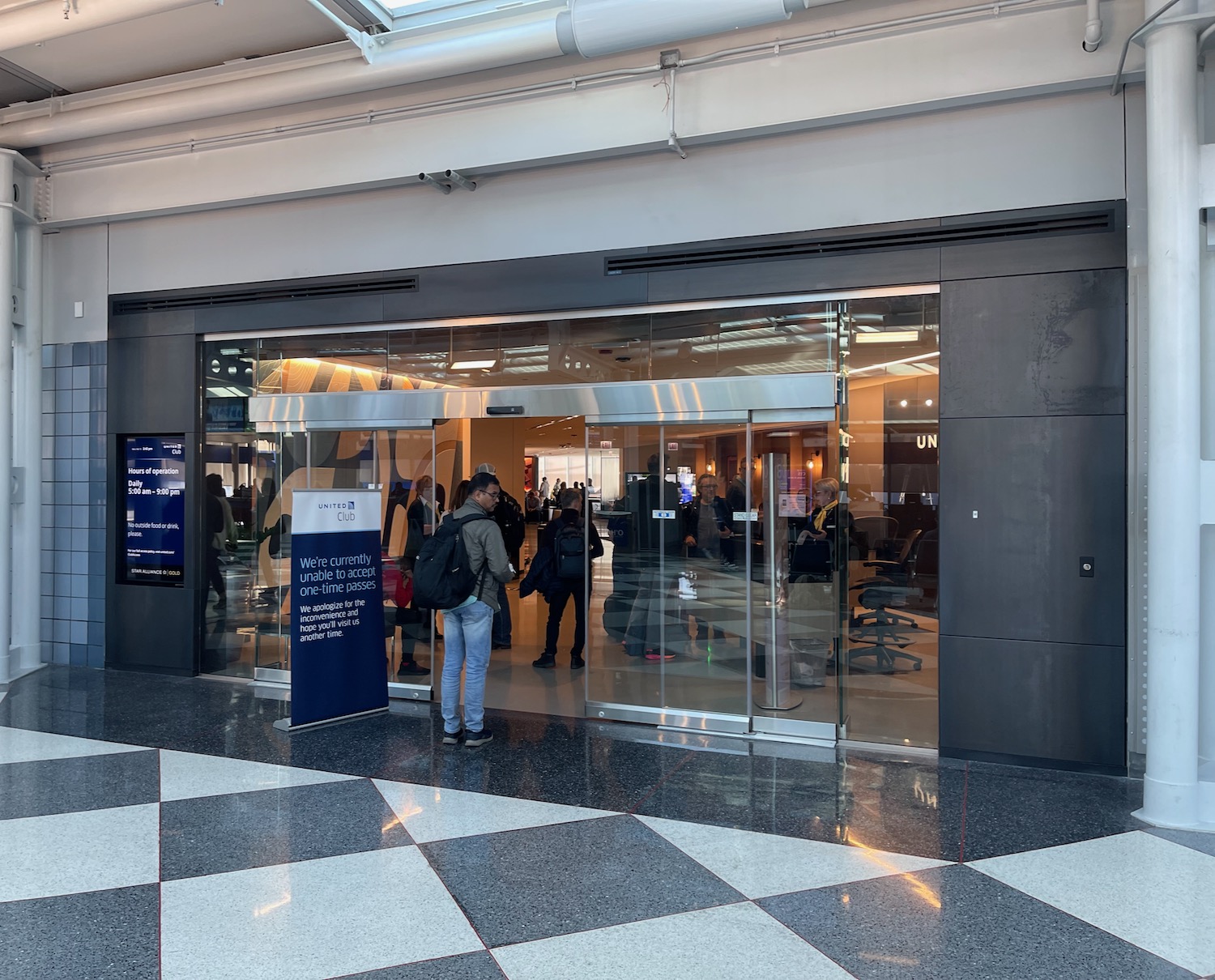 a group of people standing in front of a glass door