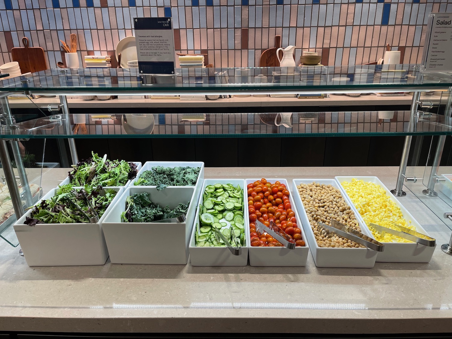 a row of containers of vegetables