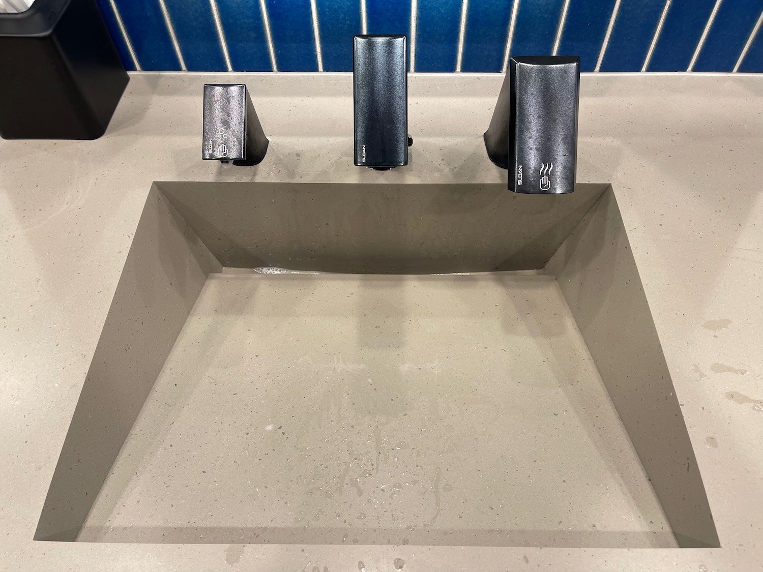 a sink with three black objects