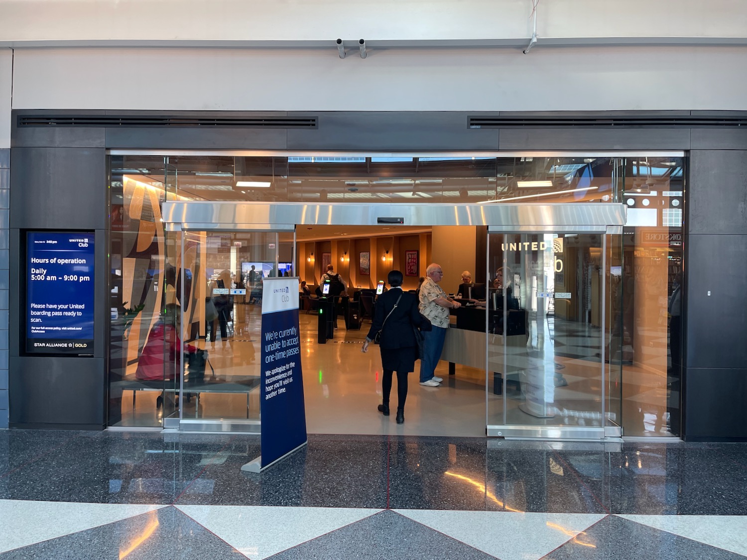 a glass door with people standing in front of it