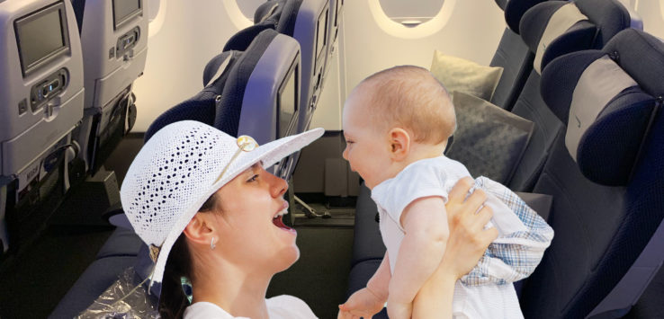 a woman holding a baby in an airplane