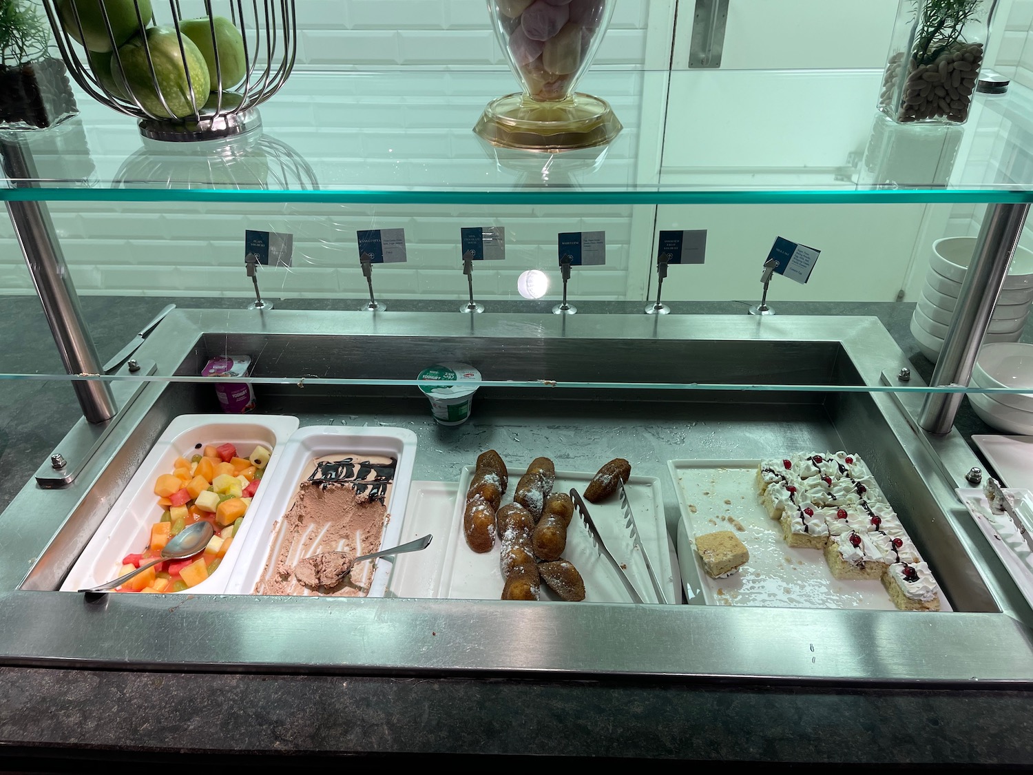 a trays of food in a glass case