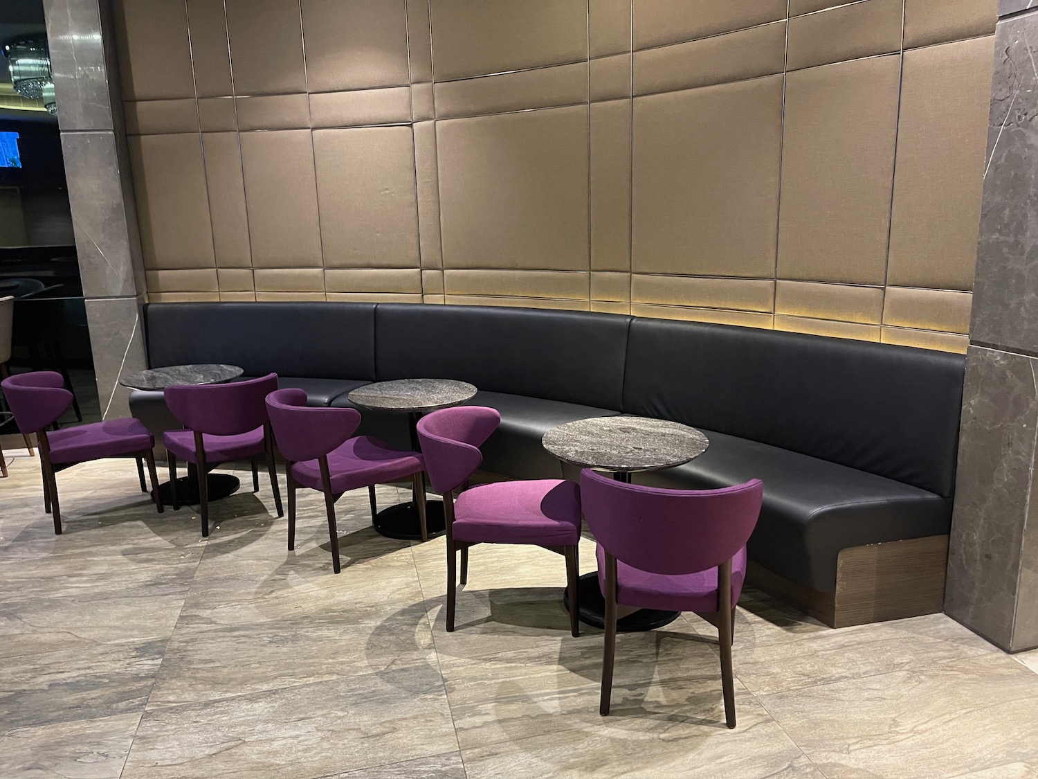 a group of purple chairs and a black booth