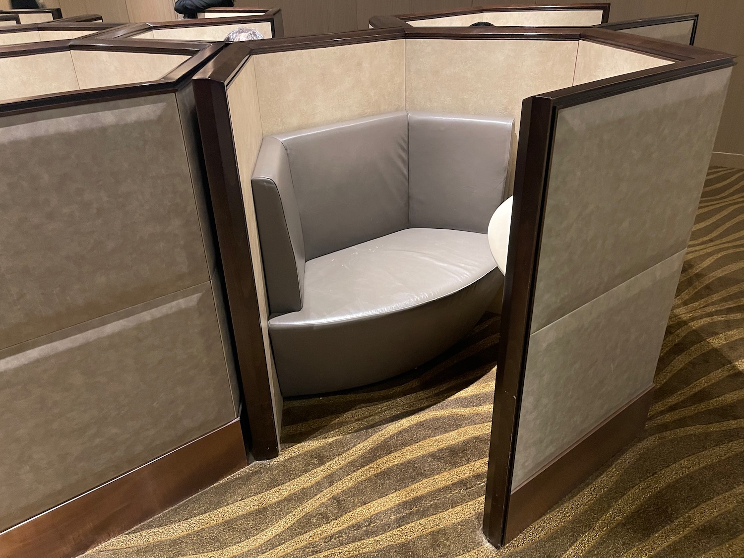 a booth with a seat and a chair in the middle