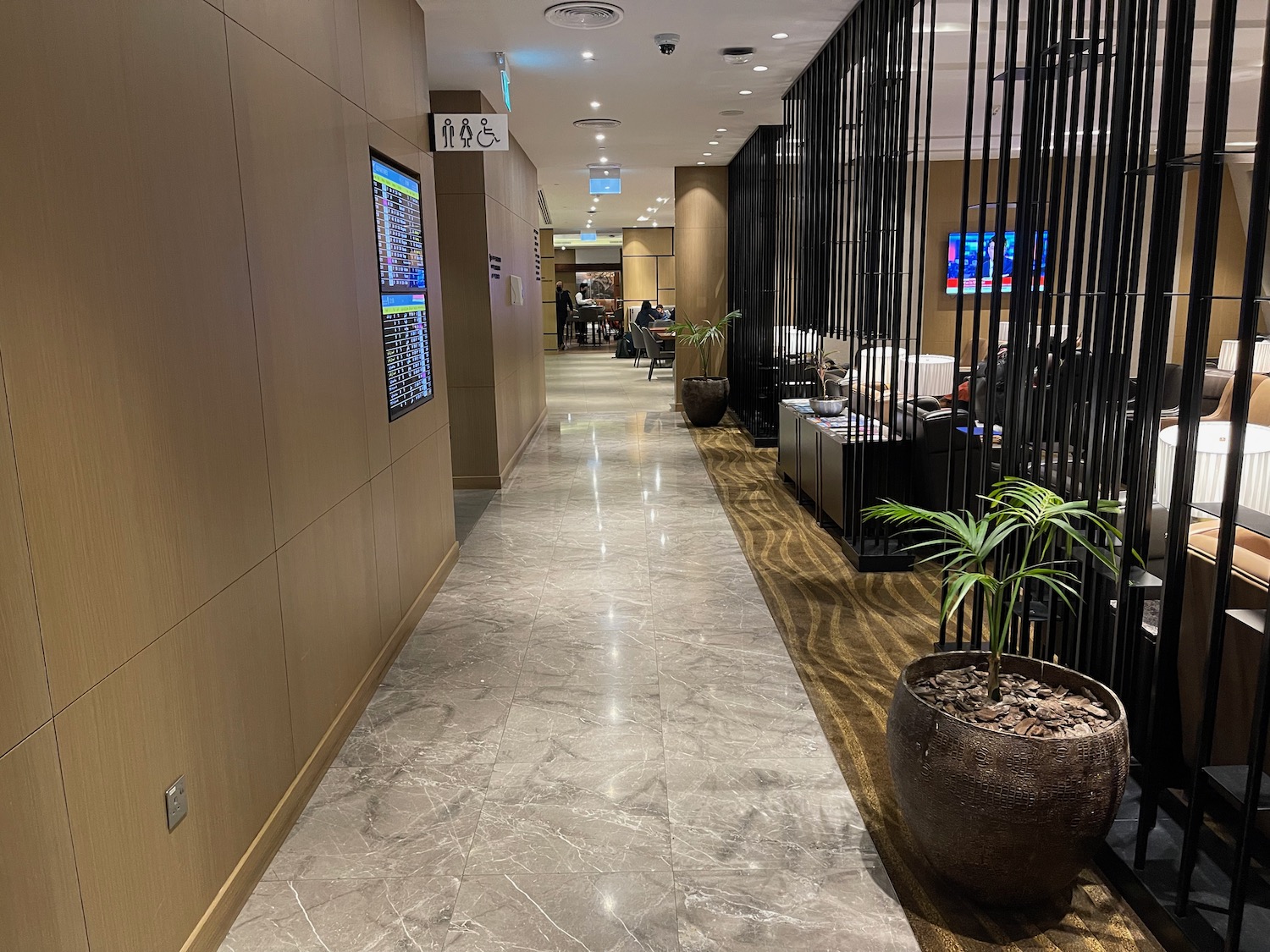 a hallway with plants and a screen