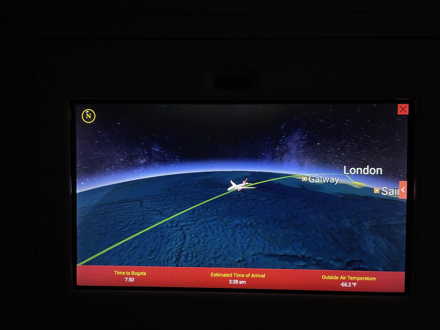 a screen shot of a plane flying over the earth