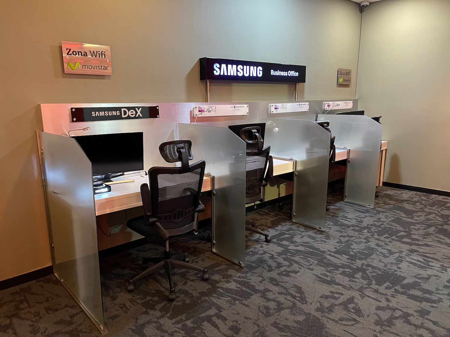 a row of computer desks in a room